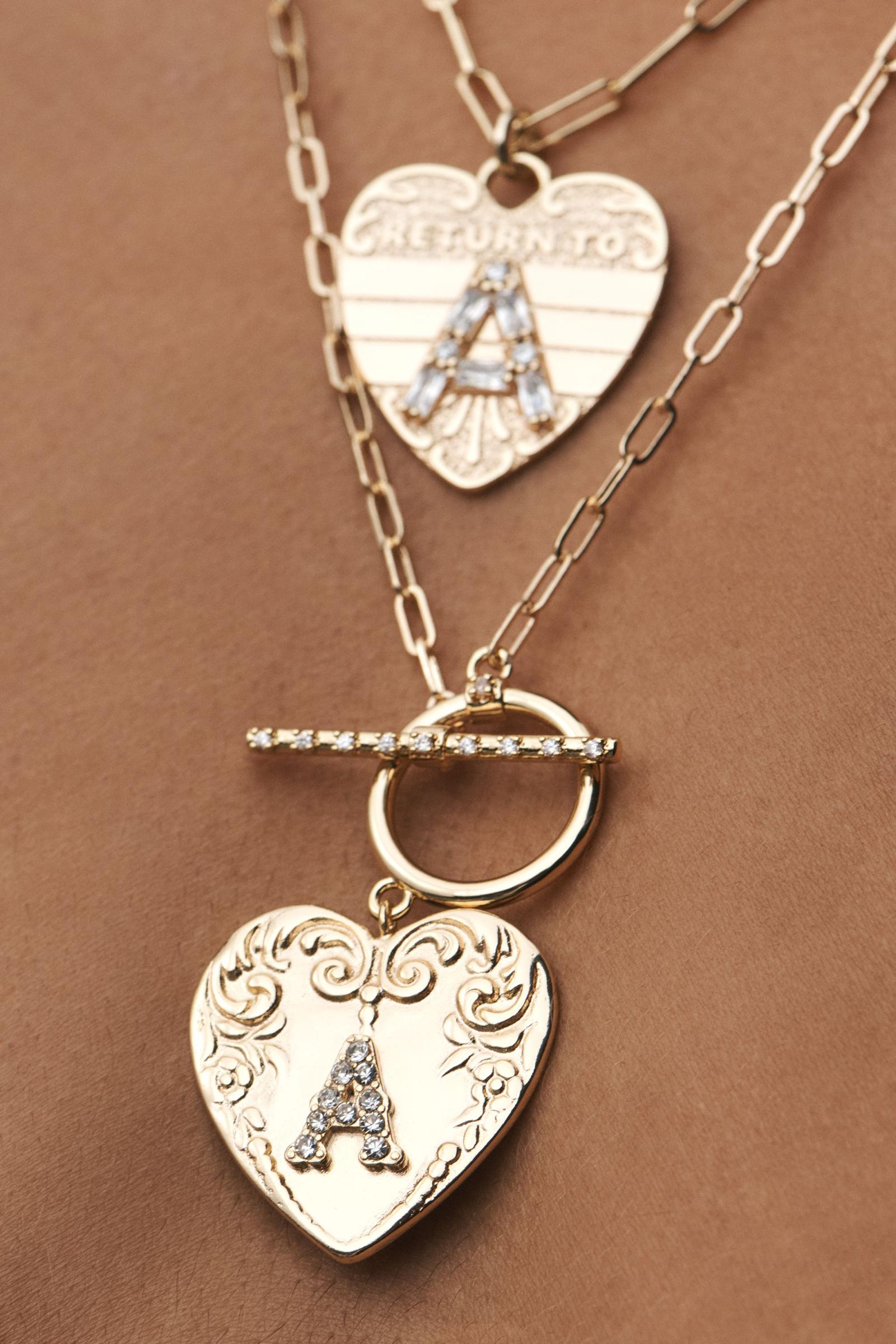 アンソロ★モノグラムハートトグルネックレス モノグラム・ハート・トグル・ネックレス | Anthropologie ホーム